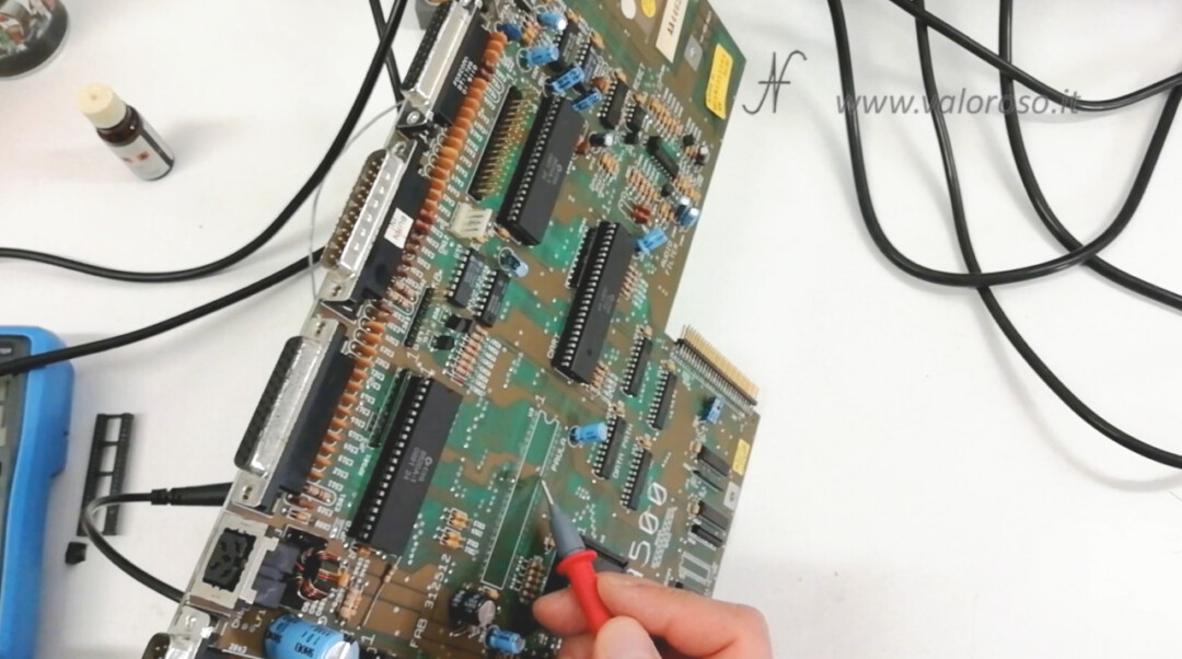 Amiga 500 PCB test with continuity tester on both sides of the printed circuit board