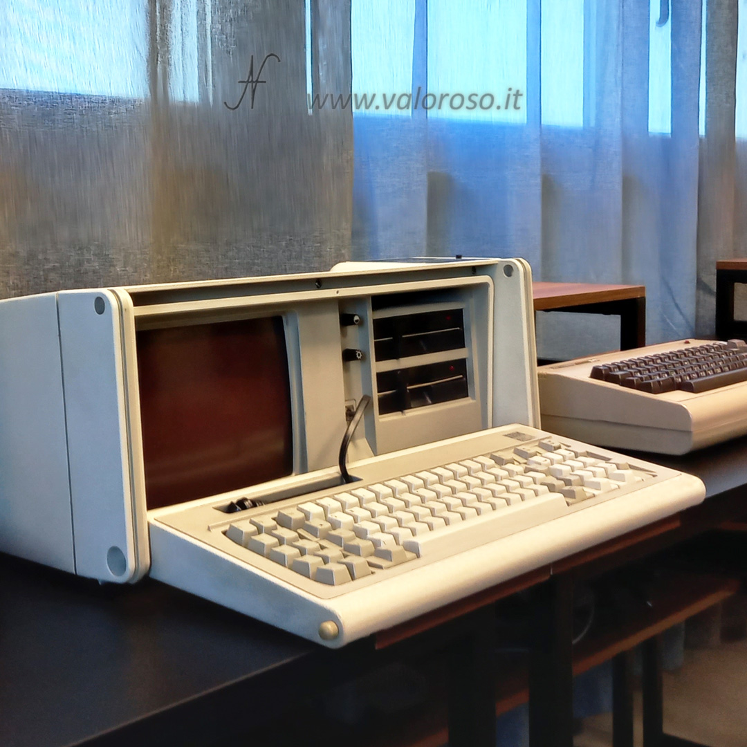 Portable laptop, IBM 5155. Year: 1984. Default programming language: Basic. QWERTY mechanical keyboard (Italian layout), 83 keys. CPU: Intel 8088, 4.77 MHz, with the possibility of expansion for 8087 mathematical coprocessor. RAM: 512 KB (256 KB minimum, expandable to 640 KB). ROME: 40 KB. Text mode: 25 rows x 80 columns. Graphics mode: CGA, 320 x 200 pixels, 640 x 200 pixels. Monitor: integrated, CRT 9", amber color. Sound: beep. Dimensions and weight: 50 x 43 x 20 cm, 13.6 Kg. Serial and parallel port. Expansion ports: 7. Drive: 2 x 5" 1/4 floppy disks (360 KB). OS: PC-DOS 2.1, IBM5155