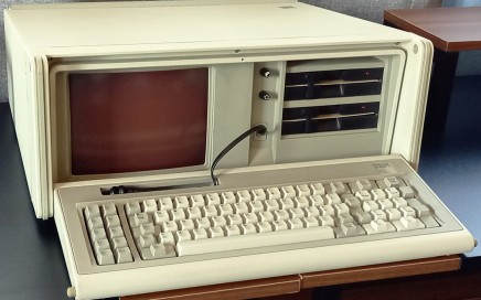 PC portatile trasportabile, IBM 5155. Anno: 1984. Linguaggio di programmazione di default: Basic. Tastiera meccanica QWERTY (layout italiano), 83 tasti. CPU: Intel 8088, 4.77 MHz, con possibilità di espansione per coprocessore matematico 8087. RAM: 512 KB (minimo 256 KB, espandibile fino a 640 KB). ROM: 40 KB. Modalità testo: 25 righe x 80 colonne. Modalità grafica: CGA, 320 x 200 pixel, 640 x 200 pixel. Monitor: integrato, CRT 9", color ambra. Suono: beep. Dimensioni e peso: 50 x 43 x 20 cm, 13.6 Kg. Porta seriale e parallela. Porte di espansione: 7. Drive: 2 x 5" 1/4 dischi floppy (360 KB). Sistema operativo: PC-DOS 2.1