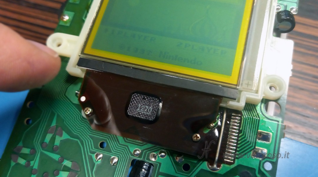 Spacer glued onto the flat cable with double-sided tape while the Game Boy Classic DMG-01 console remains switched on for control.
