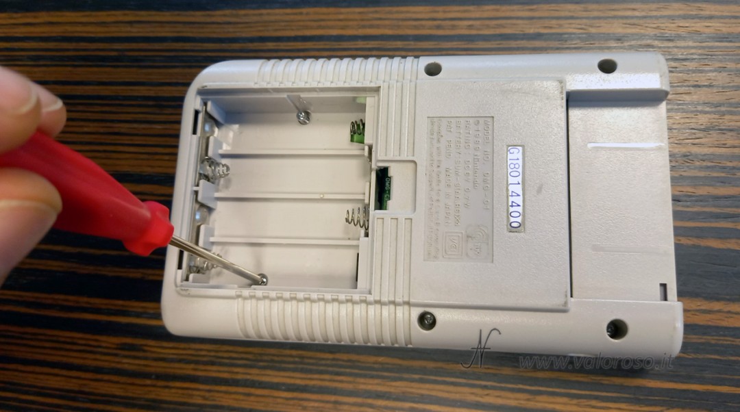 Tri-wing screws on the back of the Game Boy and dedicated screwdriver purchased on AliExpress. Opening the console preparatory to repairing GameBoy monitor vertical lines.