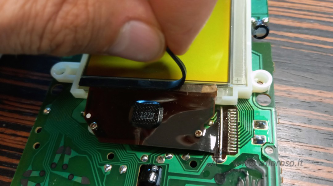 Rubber spacer on the display membrane cable: element to be detached and removed.