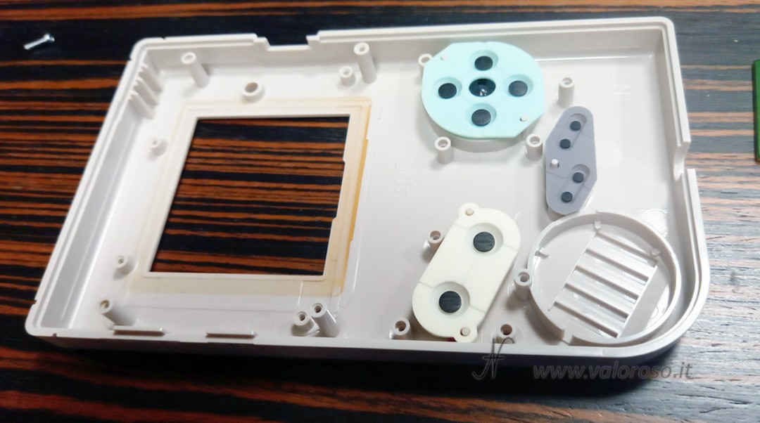 Reassembling the buttons and membranes of the GameBoy Classi before closing the display board in the shell.